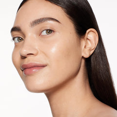 Shiseido RevitalEssence brush-usage image shows blending for seamless glow
