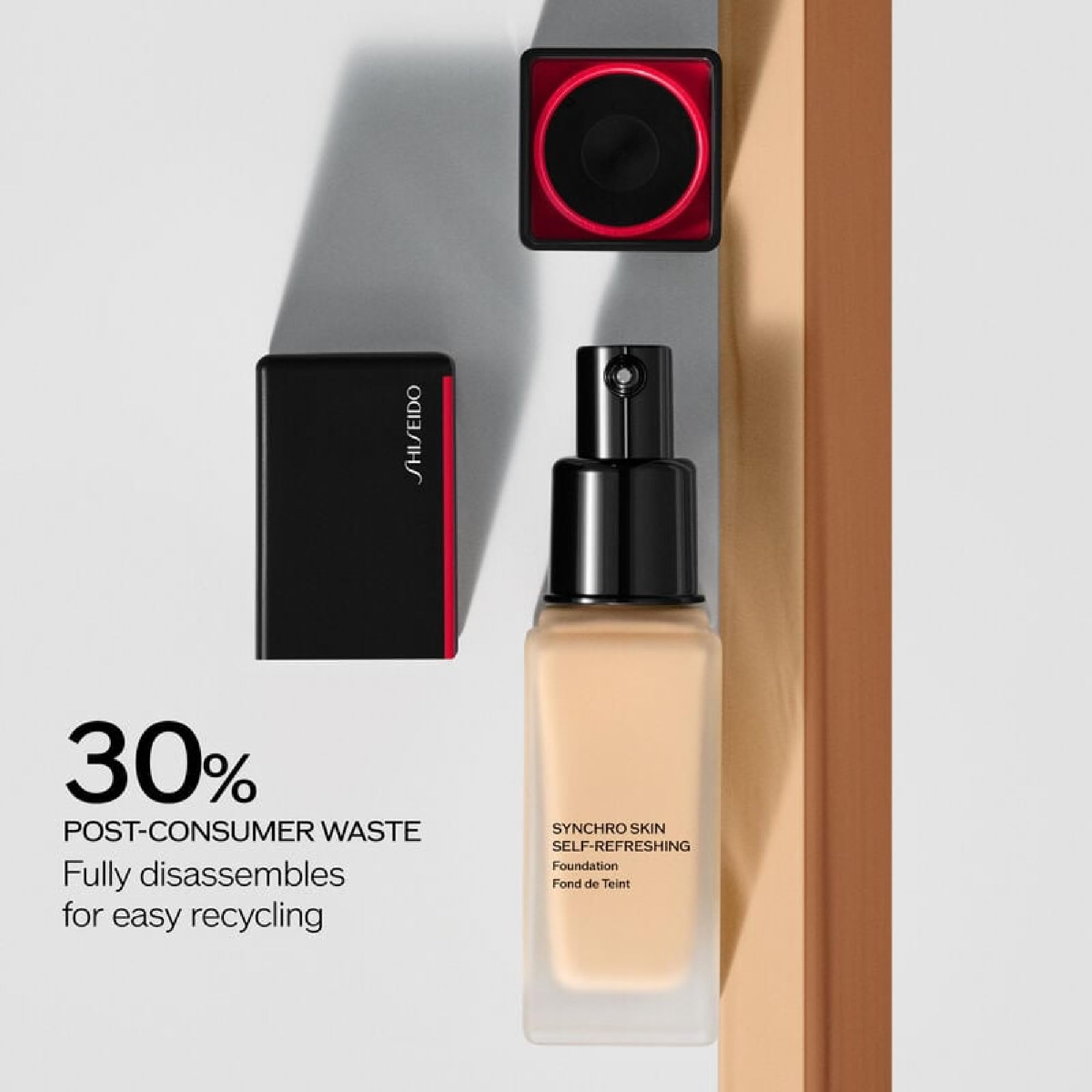 Applying Shiseido Synchro Skin foundation for seamless pore-minimized look