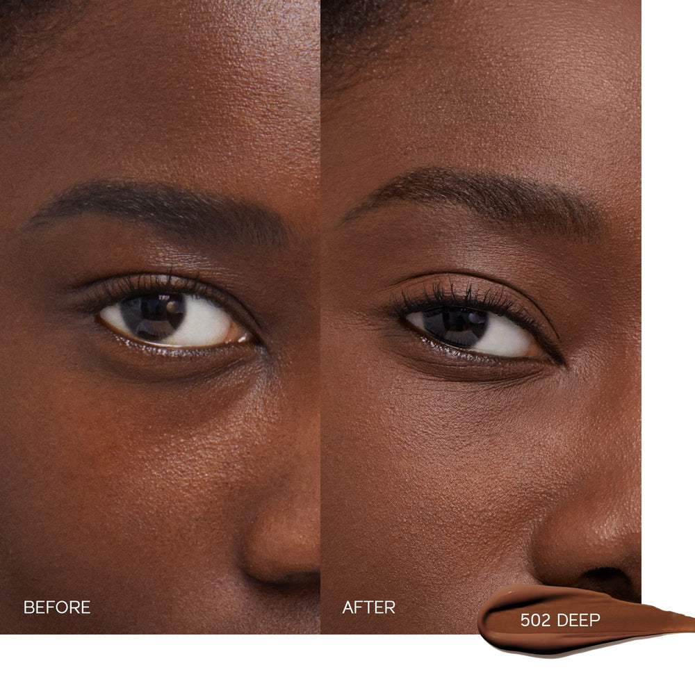 Application close-up of Shiseido Concealer Deep 502 for smooth blending.