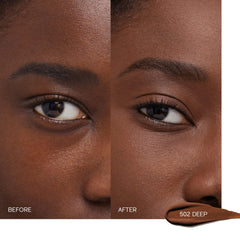 Application close-up of Shiseido Concealer Deep 502 for smooth blending.