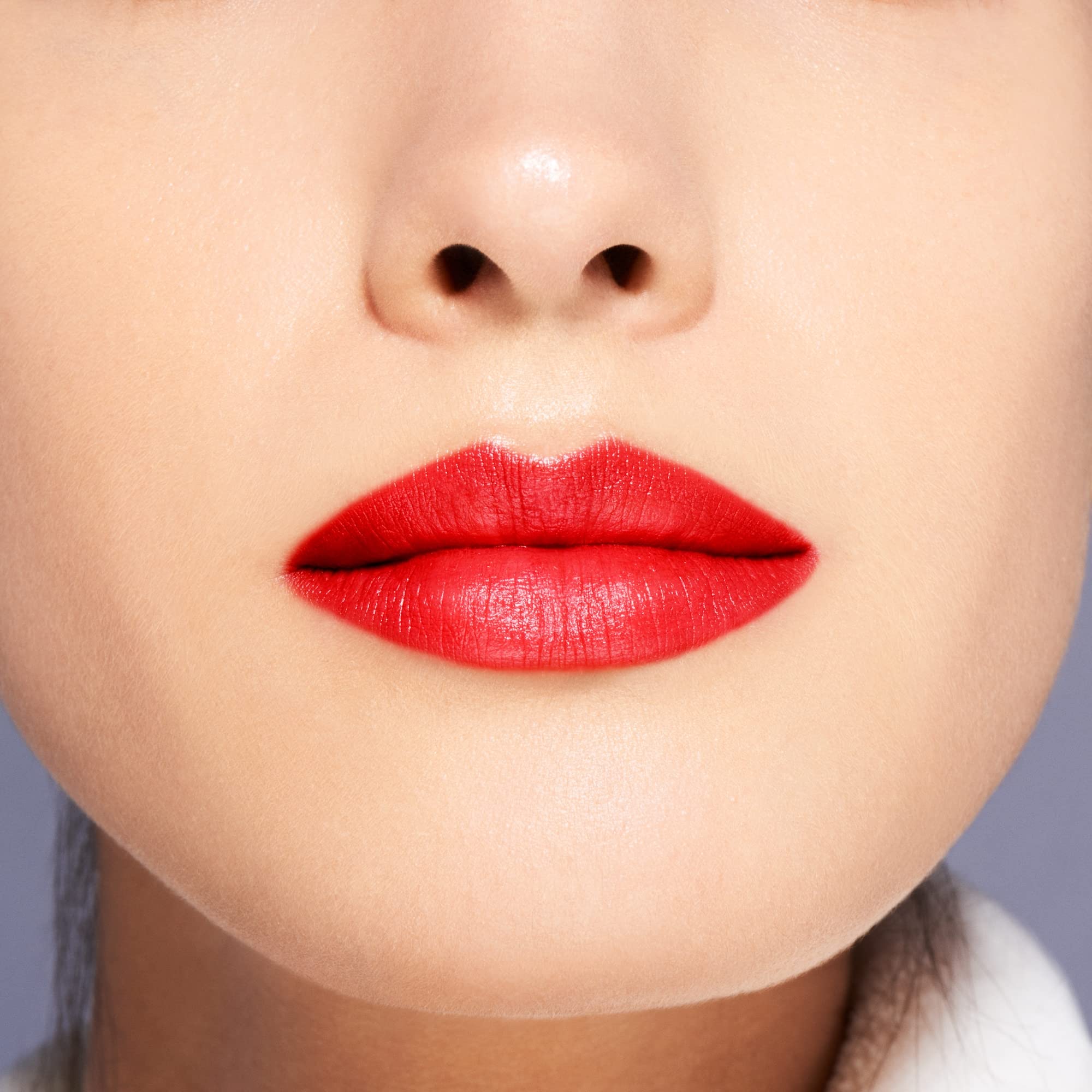 Shiseido VisionAiry Firecracker 219 lip swatch on lips shows high-impact color.