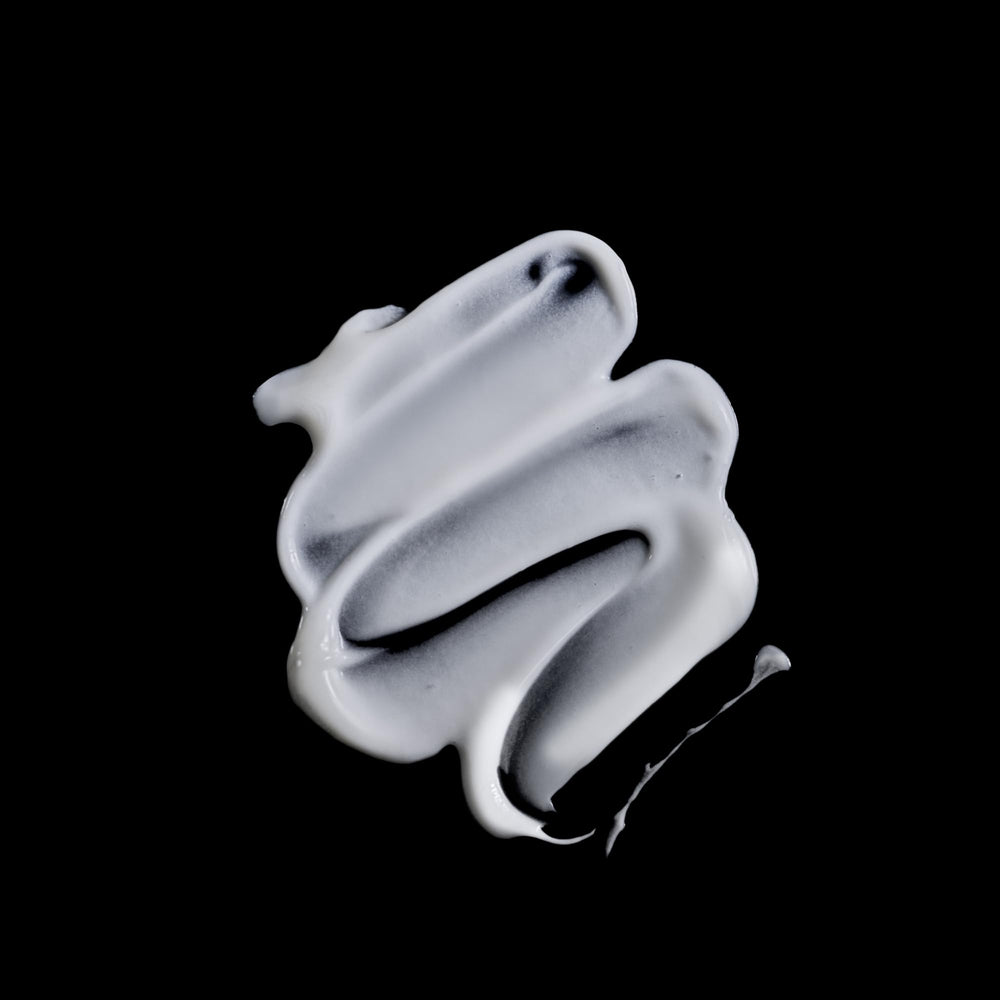 Texture close-up of Sisley Paris Curl Care Cream reveals silky, smoothing finish.