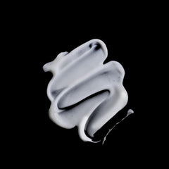 Texture close-up of Sisley Paris Curl Care Cream reveals silky, smoothing finish.