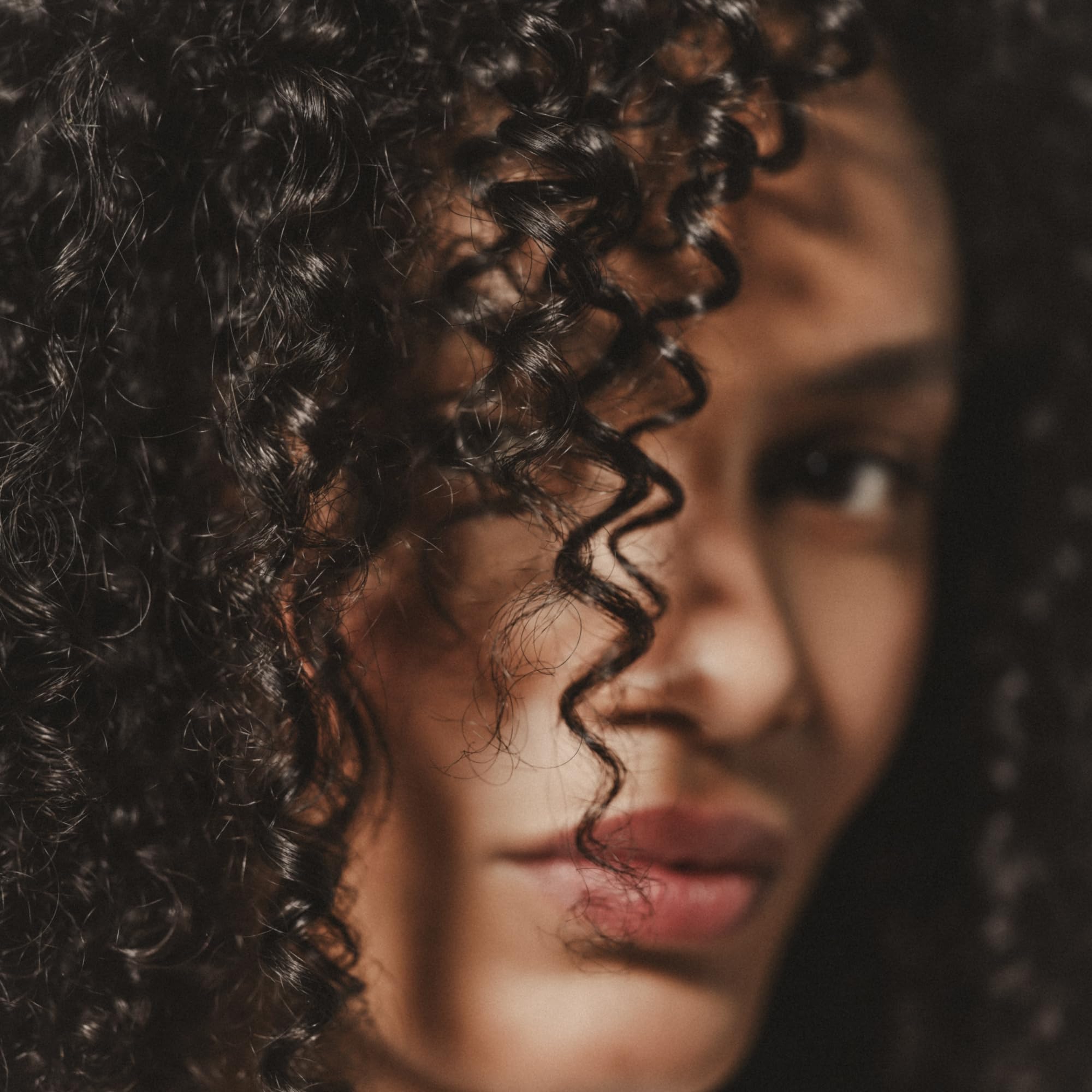 Close-up shows defined curls with lasting hold from the cream.