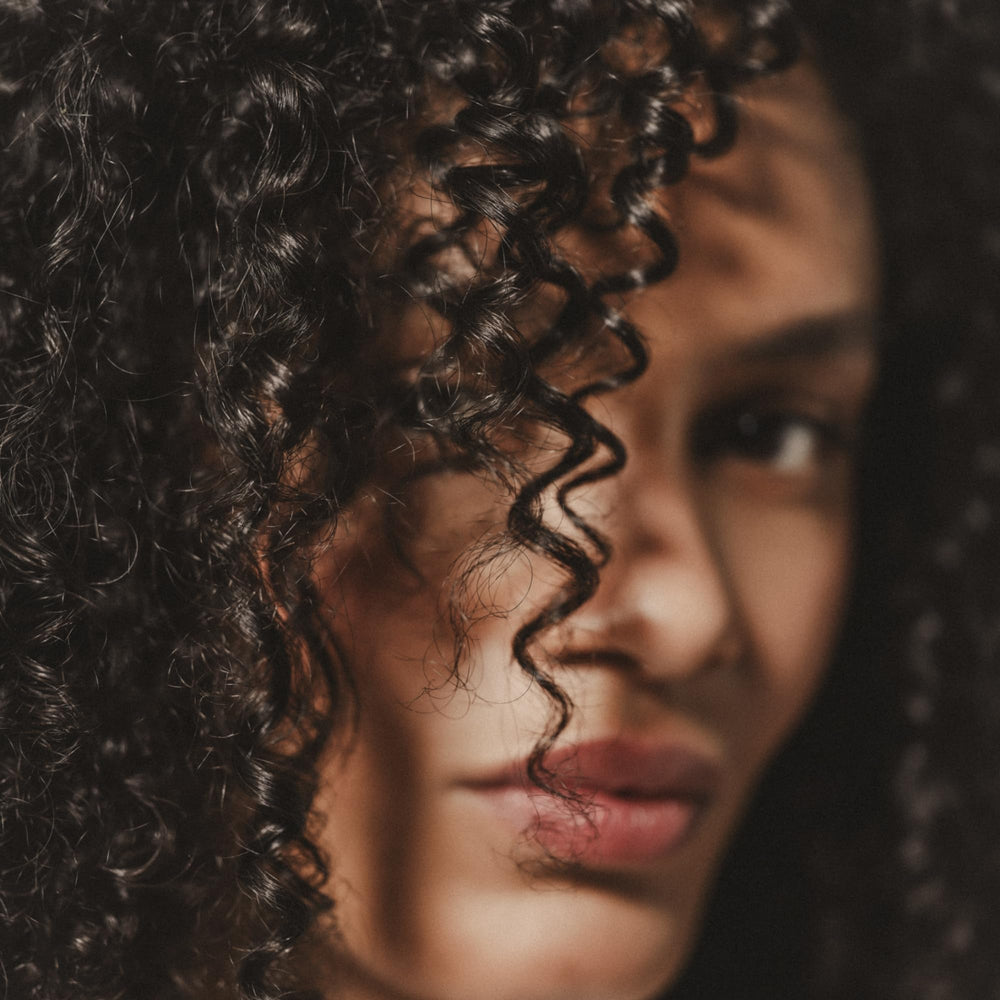 Close-up shows defined curls with lasting hold from the cream.