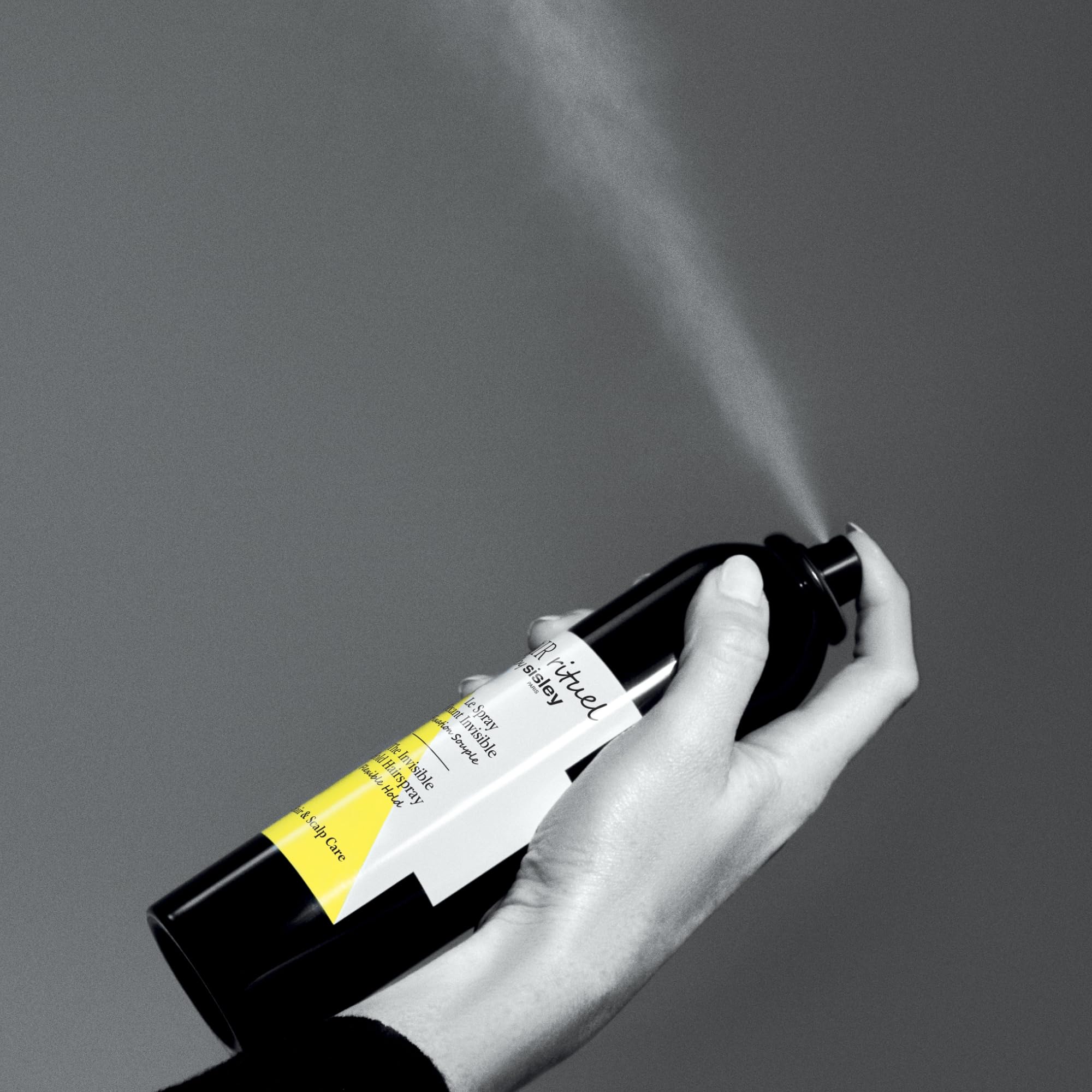 Sisley Paris invisible hold spray applied at roots for lift and texture.
