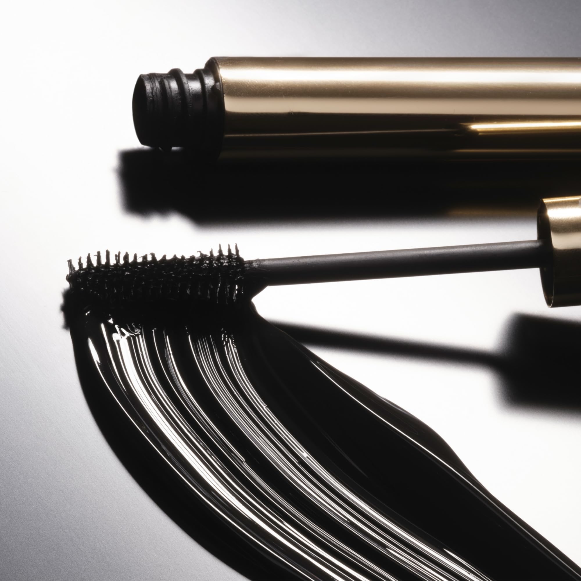 Phyto-Noir Mascara bottle and wand during application demo.