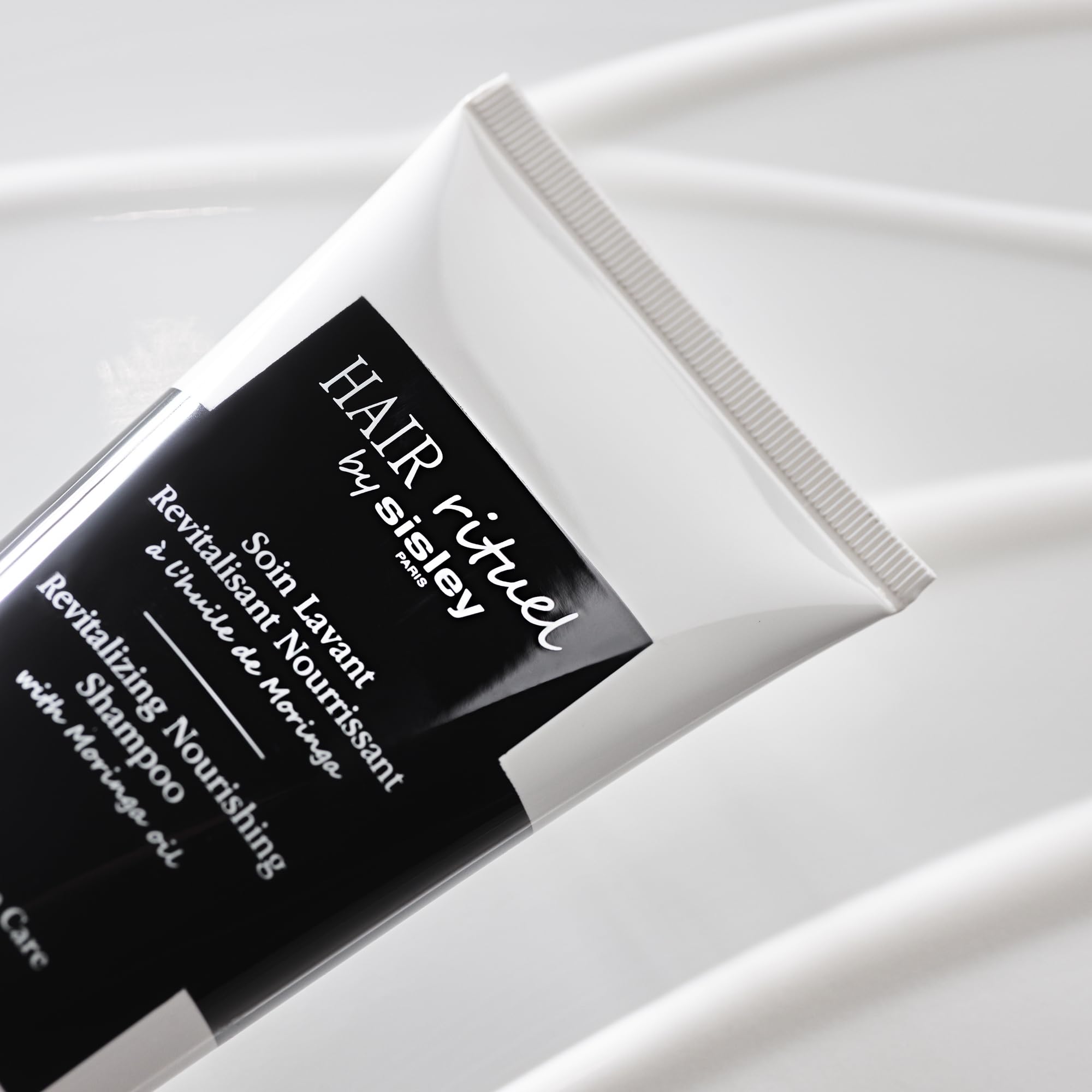 Scalp massage scene with Sisley Paris shampoo highlighting soothing care