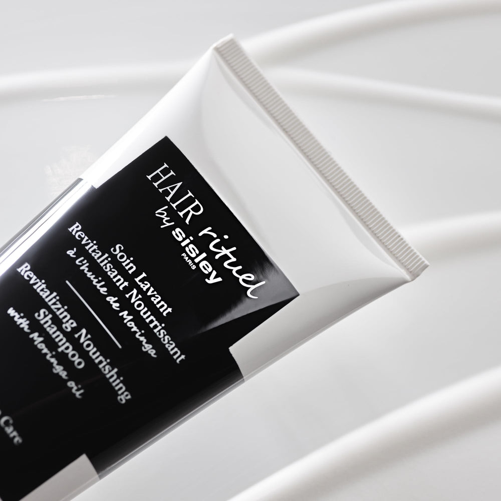 Scalp massage scene with Sisley Paris shampoo highlighting soothing care