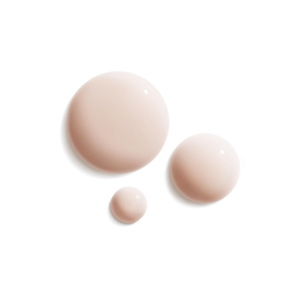 Sisley Paris serum drops dispensed showing precise application for longevity care.