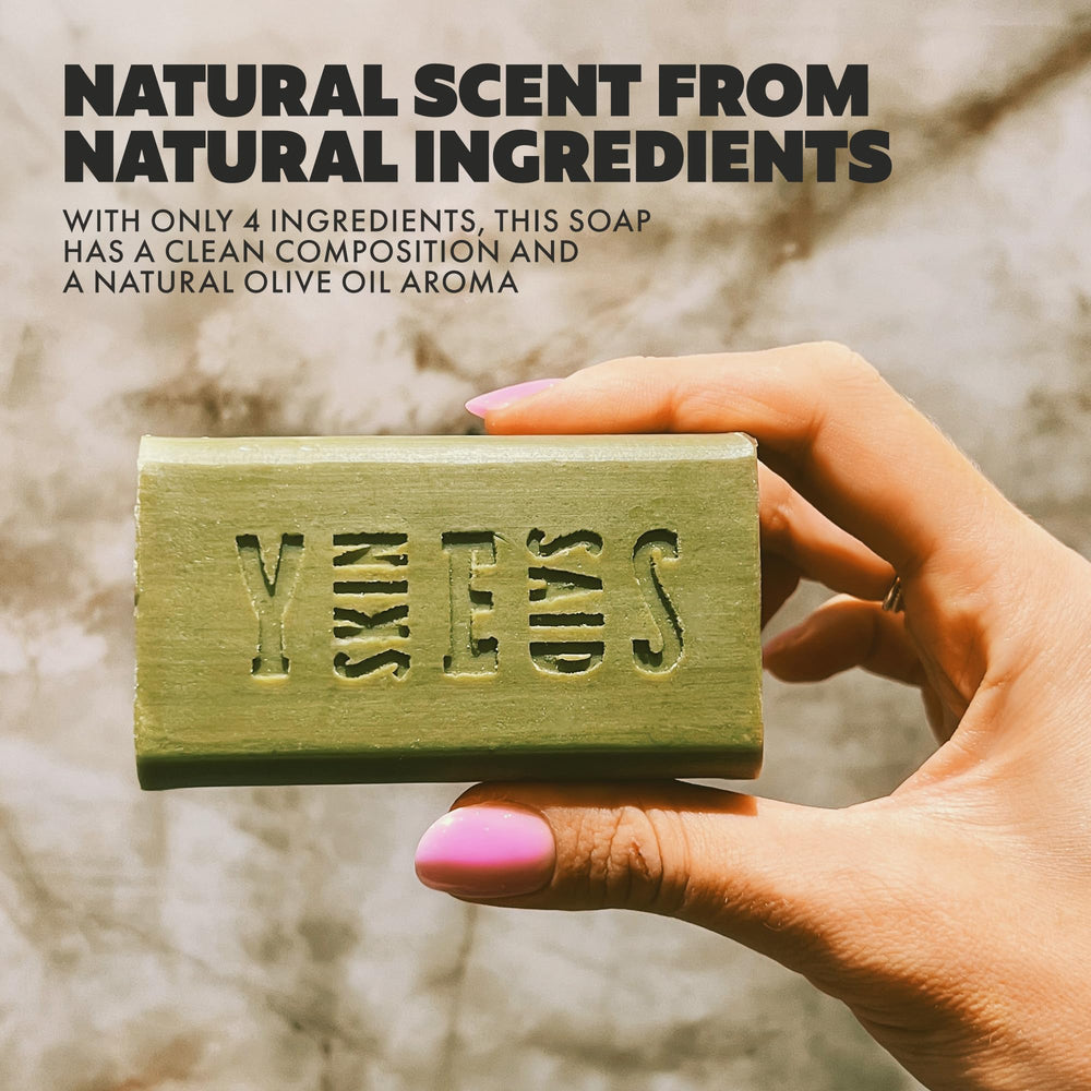 Skin Said Yes soap bar in hand demonstrating easy cleansing on the go.