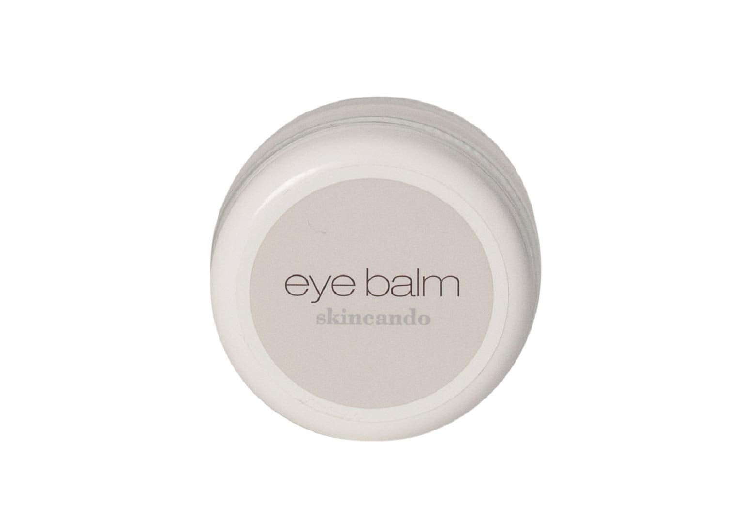 Skincando Eye Balm jar highlighting dark circles and brightened under-eye area.