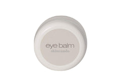 Skincando Eye Balm jar highlighting dark circles and brightened under-eye area.