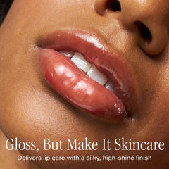 SKINN Luminous Lip Oil Crimson gloss on lips provides a non-sticky, glassy finish.