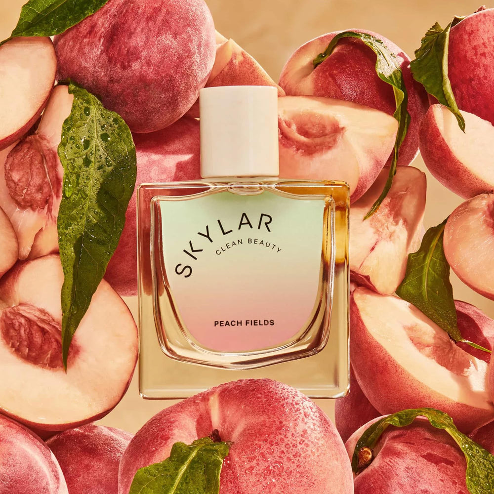 Skylar Peach Fields base notes visual with cashmere woods and sandalwood warmth.