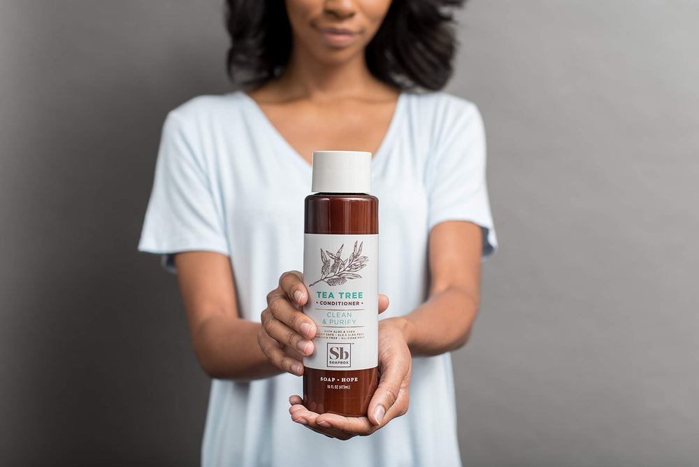 Applying Soapbox Clean and Purify Tea Tree Conditioner for lightweight hydration.