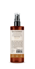 Fine mist from Soapbox Mane Tamer applied to hair for smooth hydration.