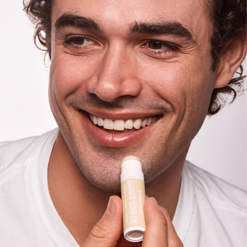Space Camp Wellness jumbo lip balm being applied for quick hydration.