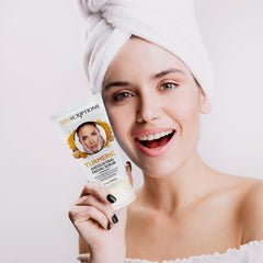 SpaScriptions Turmeric scrub texture close-up reveals exfoliating beads for smoother skin.