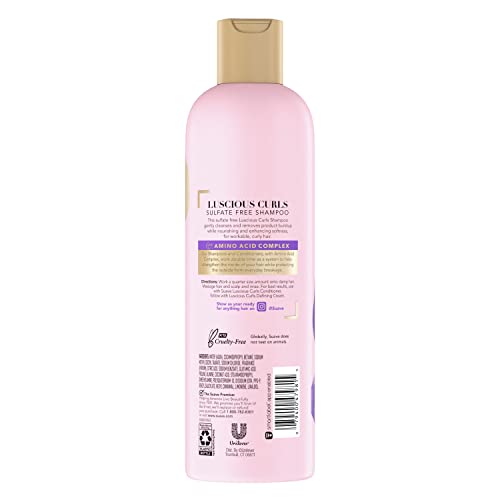 Close-up of rich lather forming on curly hair with Suave Pink Luscious Curls Shampoo.