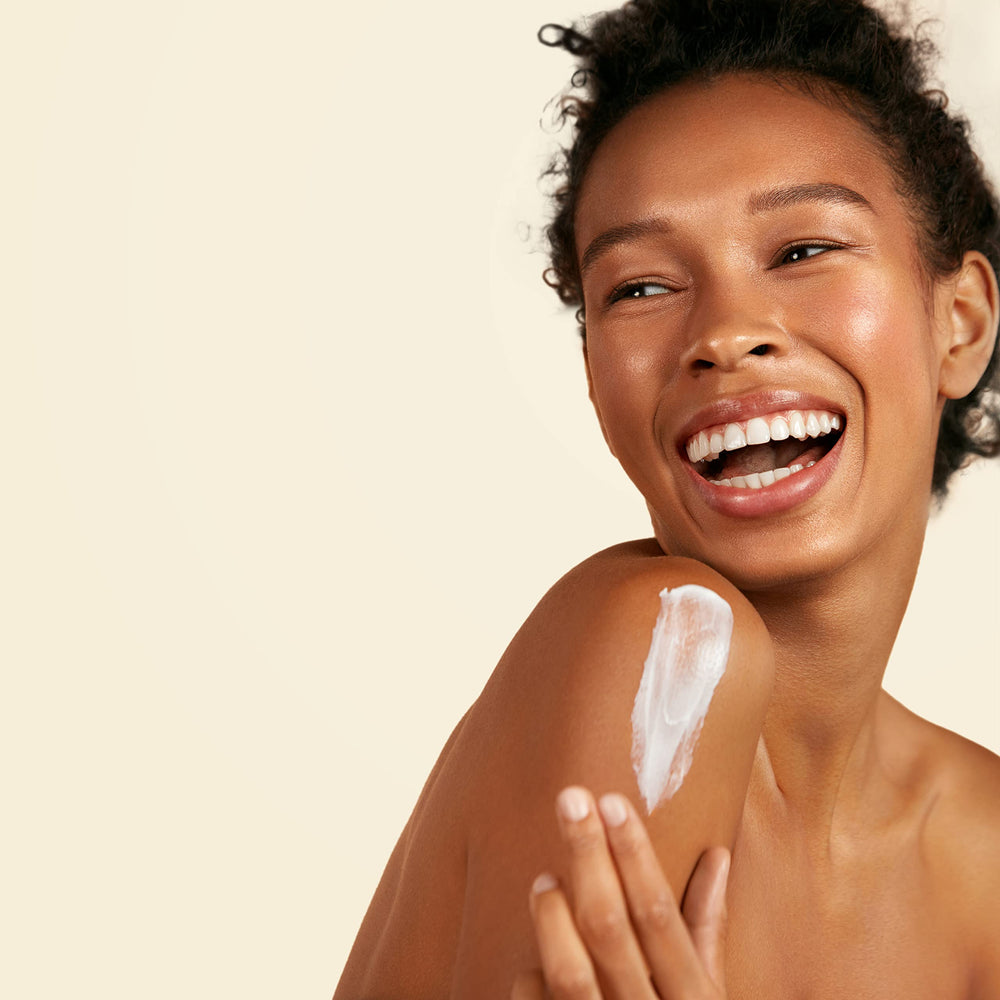 Hand applying Suave Skin Lotion to forearm demonstrates lightweight hydration