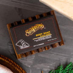 Hands lathering with Suavecito soap showing rich foam and scent.