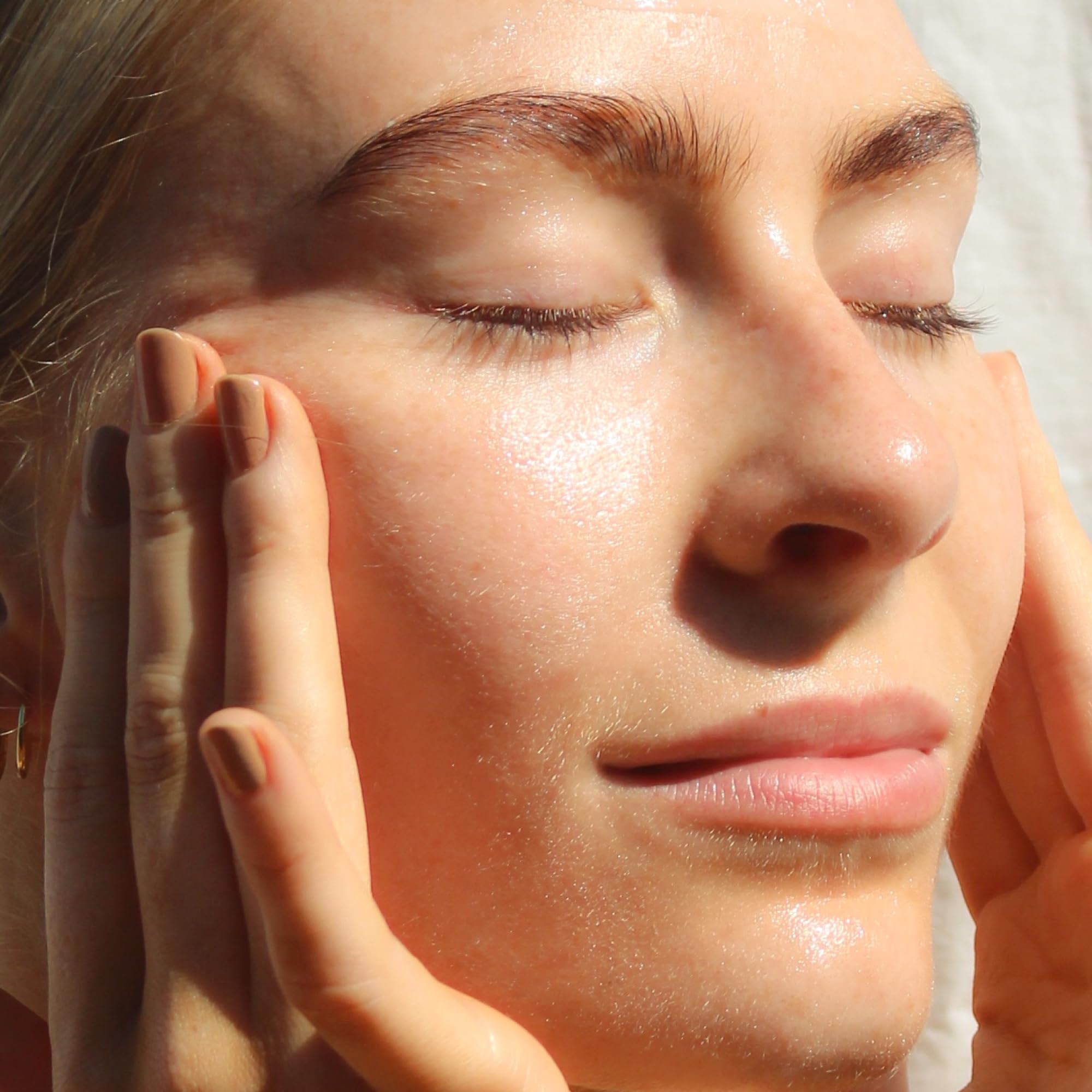 Summer Fridays Cloud Dew in hand applying for instant hydrating glow.