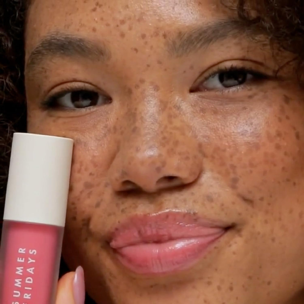 Applying Dream Lip Oil on lips for a smooth, non-sticky feel.