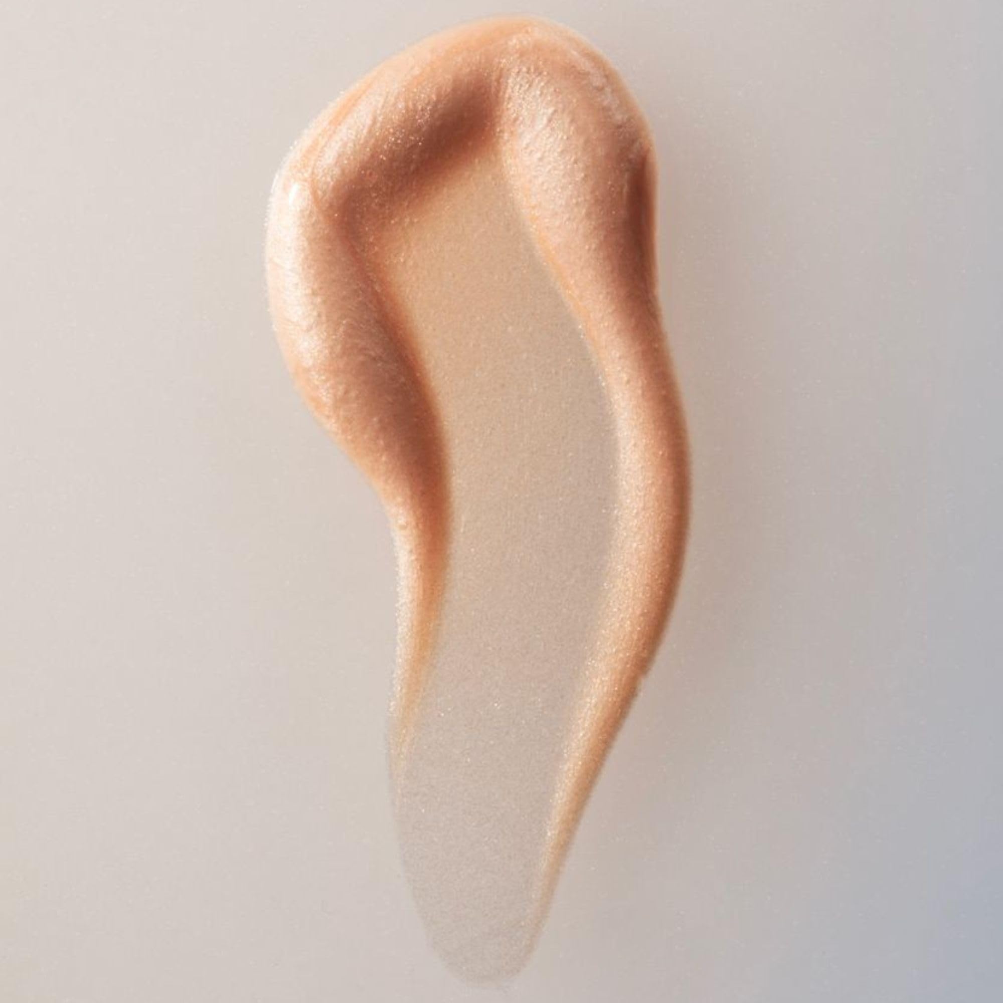 Hand applying Summer Fridays Illuminating Drops for quick radiant glow