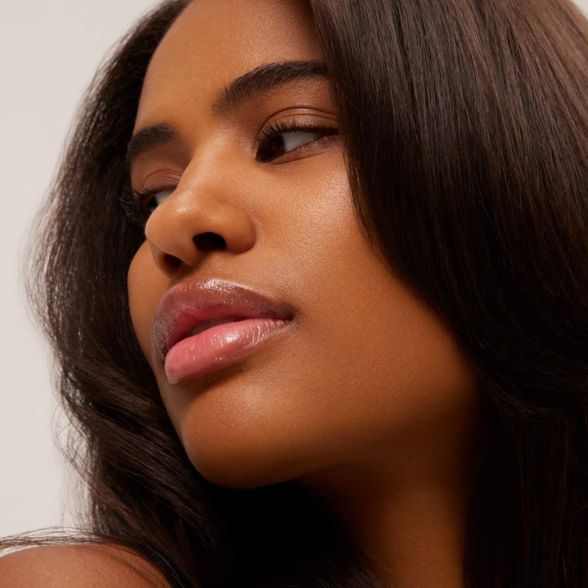 Summer Fridays lip butter on a vanity beside skincare routine