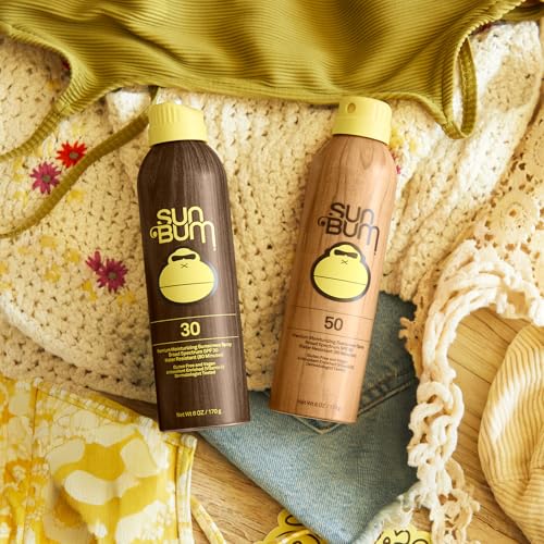 Sun Bum sunscreen spray mist on skin demonstrates easy, even application outdoors.