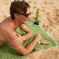 Sun Bum water-resistant sunscreen shown during swimming.