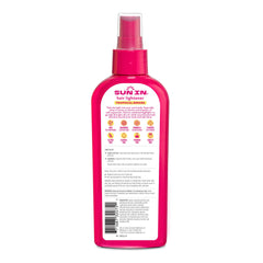 Sun-In mist application demonstrates quick, even coverage on damp hair.
