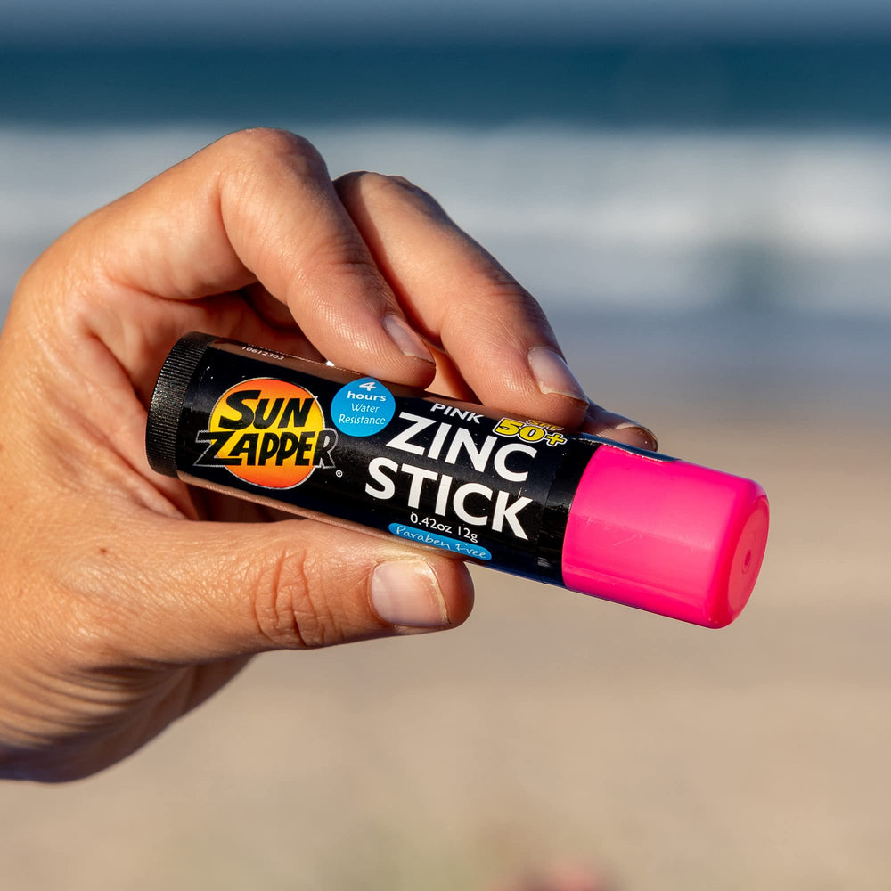 Sun Zapper sunscreen sticks in a compact beach-trip kit.