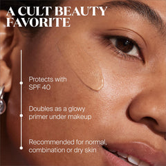 Glow Stick SPF 50 on cheek demonstrates dewy highlight portability.