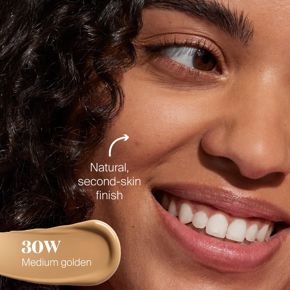 Fingers blending Protec(tint) on the cheek for a smooth finish