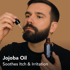 Hands applying Superior Mane beard oil through beard and mustache