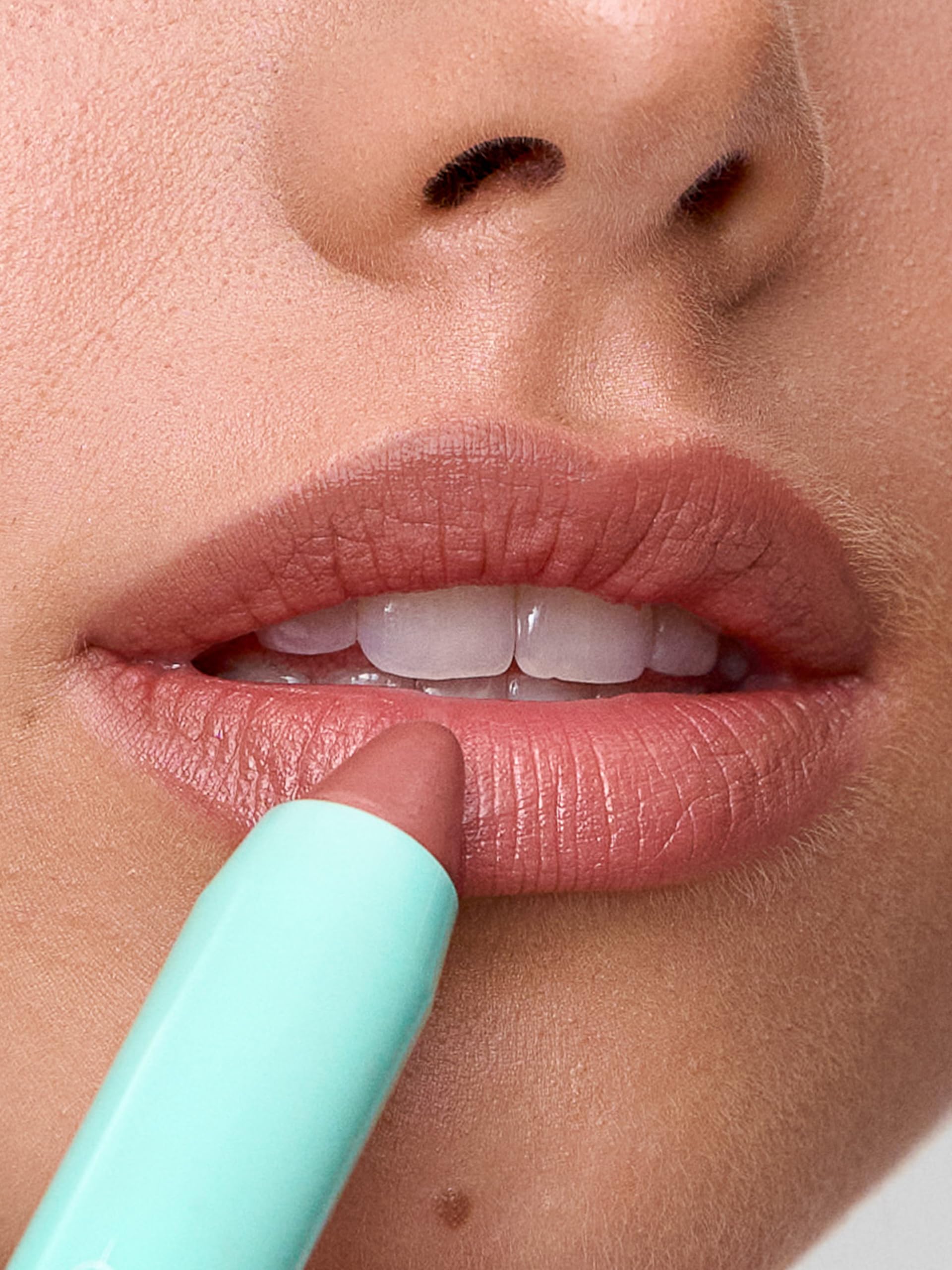 Sweed Le Lipstick swatches show buildable nude-warm Wild Rose color for daily wear.