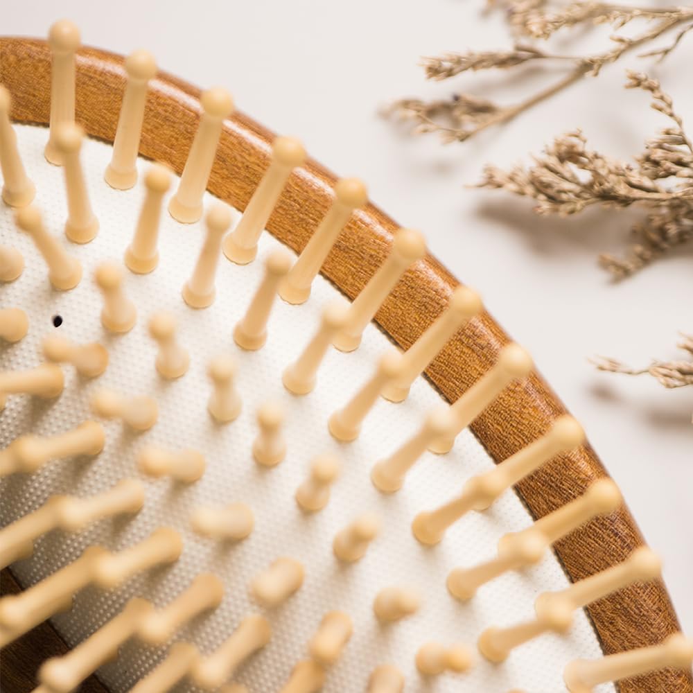 Tan Mujiang hair brush in use for comfortable styling sessions
