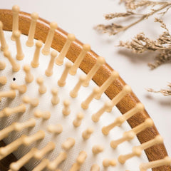 Tan Mujiang hair brush in use for comfortable styling sessions