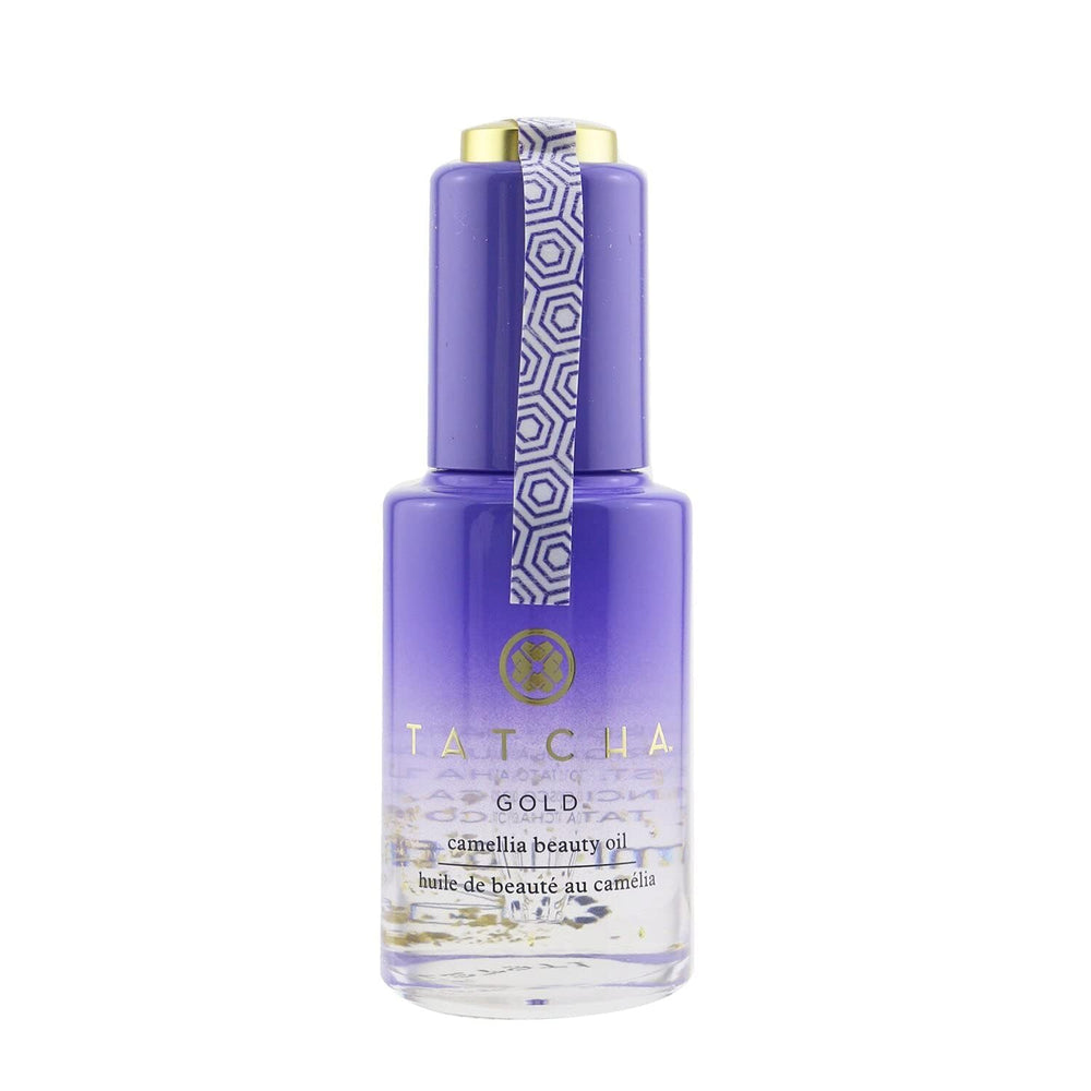 TATCHA Gold Camellia Beauty Oil bottle close-up with 23k gold flakes for radiant glow.