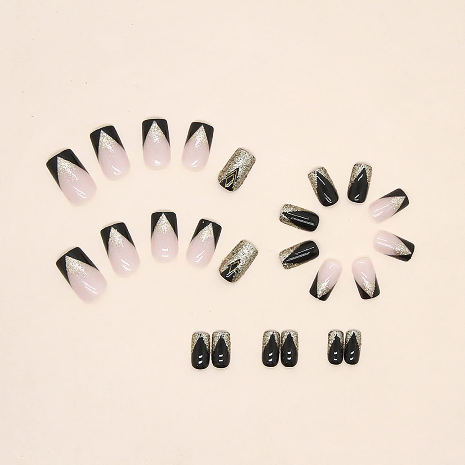 TBRZTR glossy glue-on nails: full-cover nude with black and gold accents.