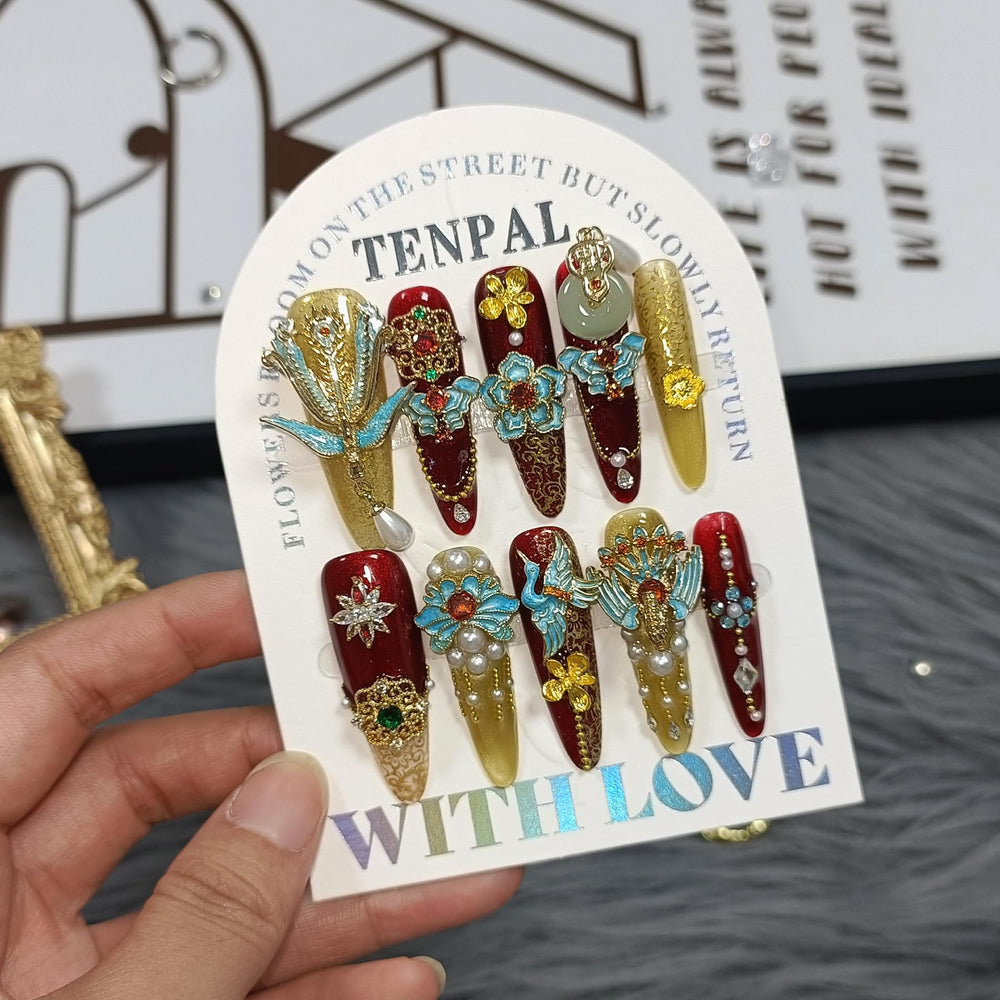 TENPAL long stiletto nails with crystal embellishments for a luxurious look.