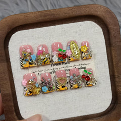 TENPAL short duckbill nails with pale-yellow French tip and 3D bee charms for chic everyday style.