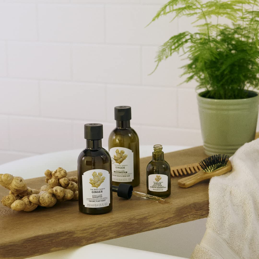 The Body Shop Ginger Scalp Serum on bathroom shelf with vegan branding