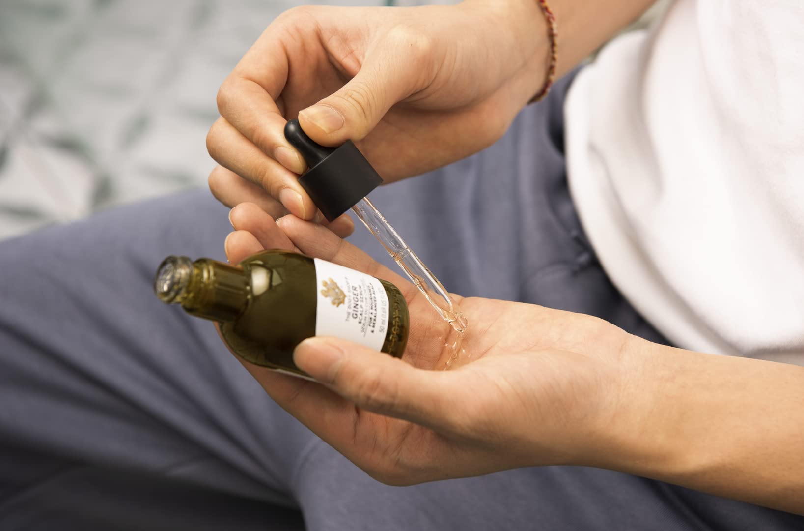 The Body Shop Ginger Scalp Serum dropper dispensing for targeted scalp care