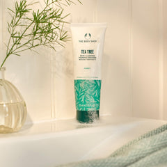 Closeup of Tea Tree cleanser bottle showing foamy action for blemish-prone skin.