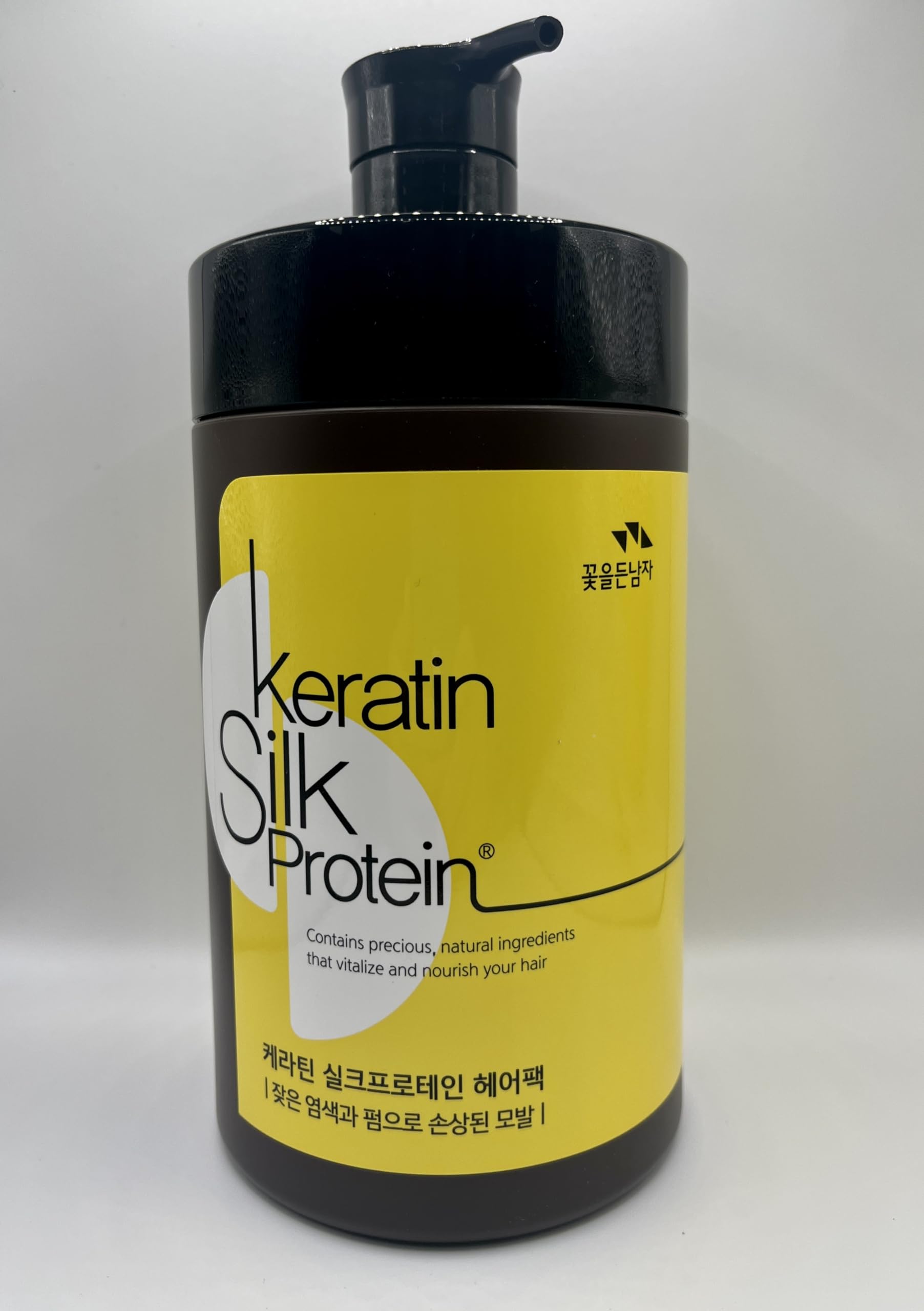 The Man Company Man with Flowers keratin silkprotein hair pack bottle closeup highlighting premium conditioning.