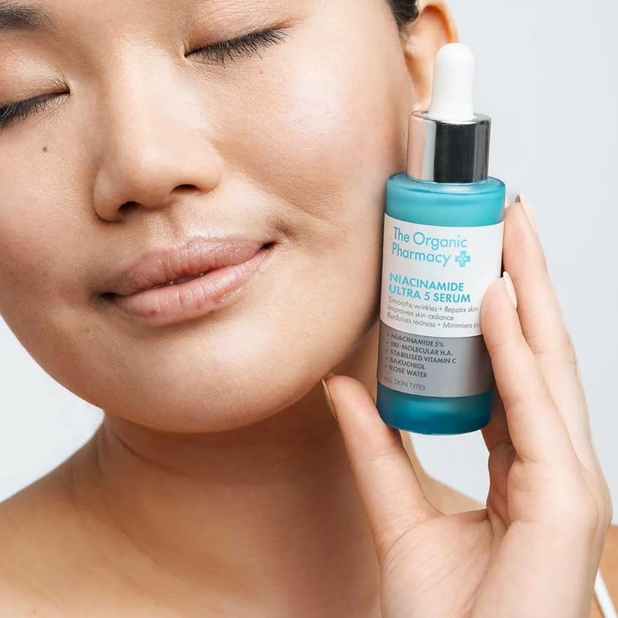 The Organic Pharmacy Niacinamide Ultra 5 Serum packaging on shelf signals premium skincare.
