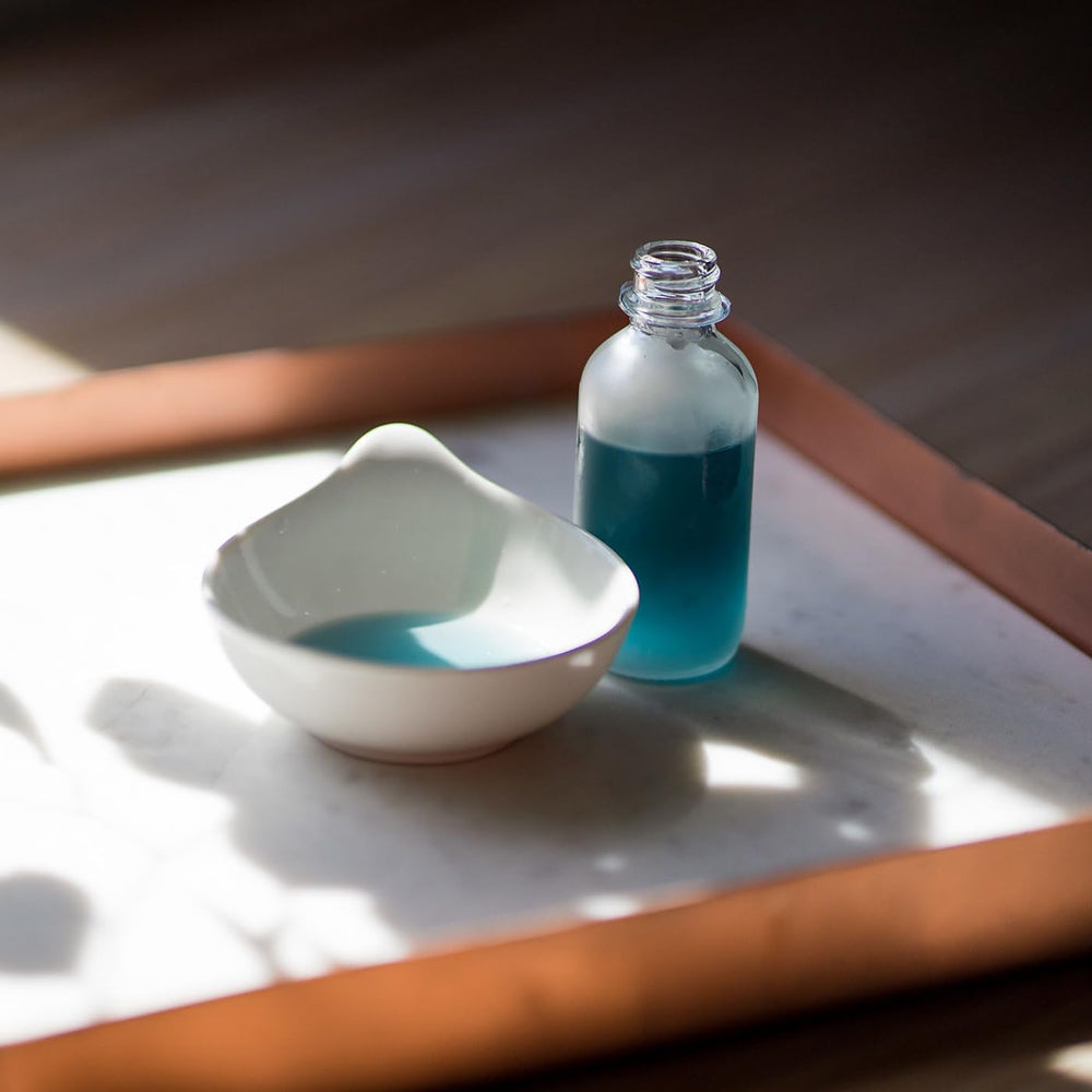 The Yellow Bird Balancing Blue Tansy Oil glow shot displays a healthy, radiant complexion.